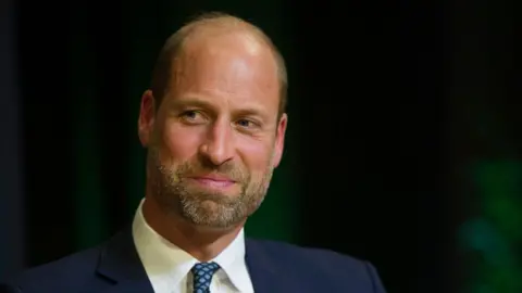 AFP via Getty Images Prince William is photographed at the Earthshot Prize awards in Rio de Janeiro on 5 November. He is wearing a dark suit, white shirt and navy and blue spotty tie.