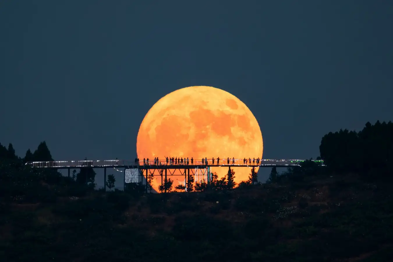 A supermoon with a bridge in front