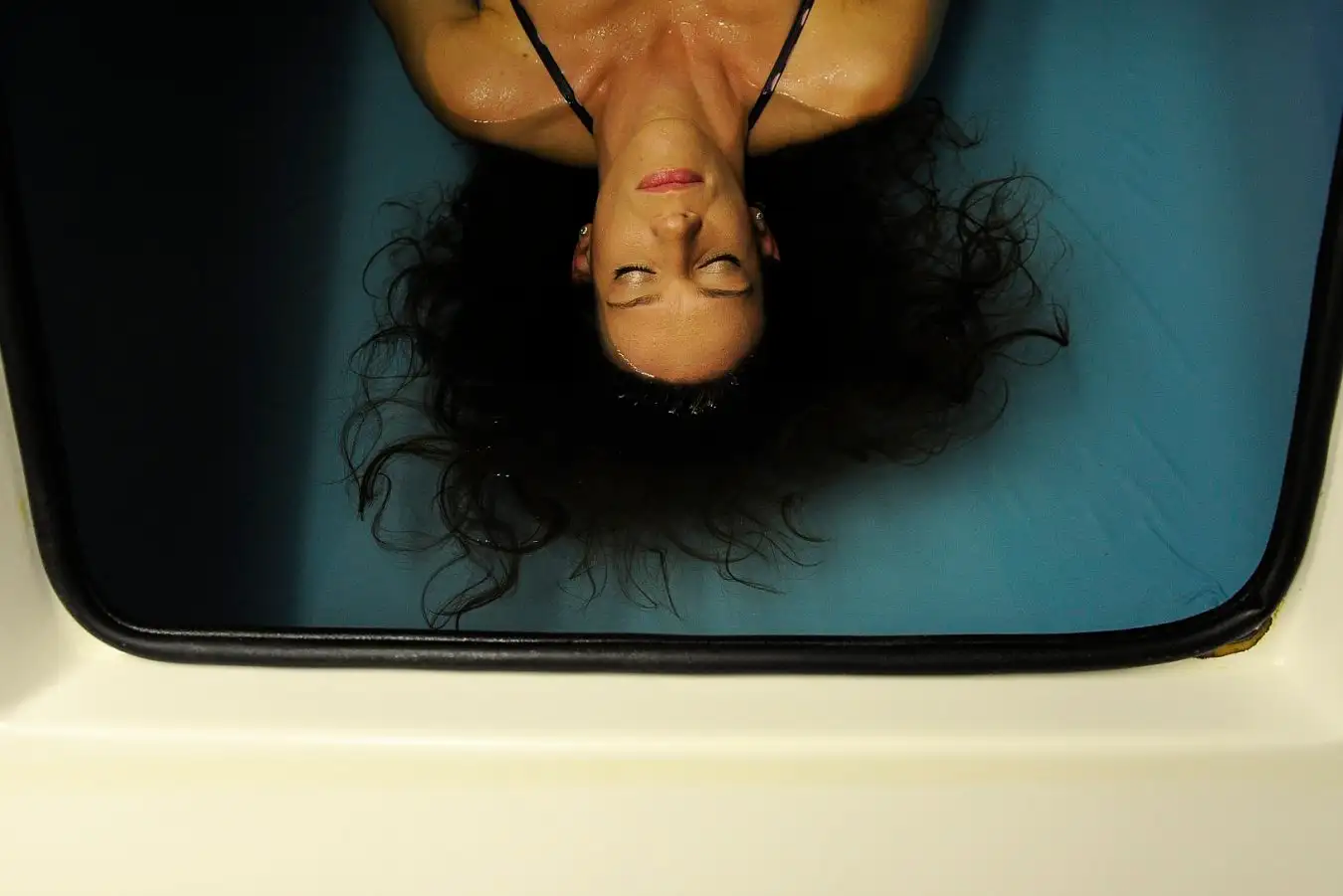 A woman rests in a flotation tank