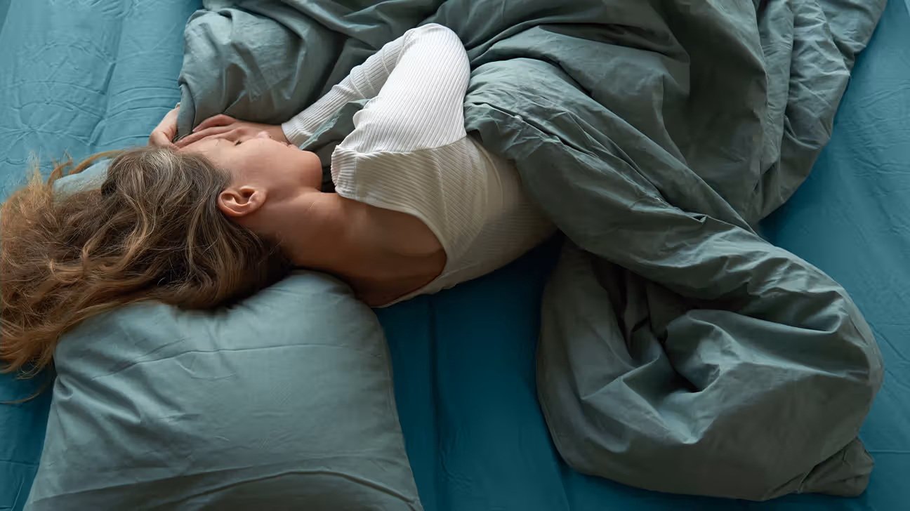 Female in bed sleeping on her side