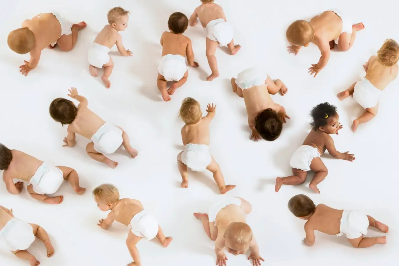 A large group of babies crawling in nappies or diapers