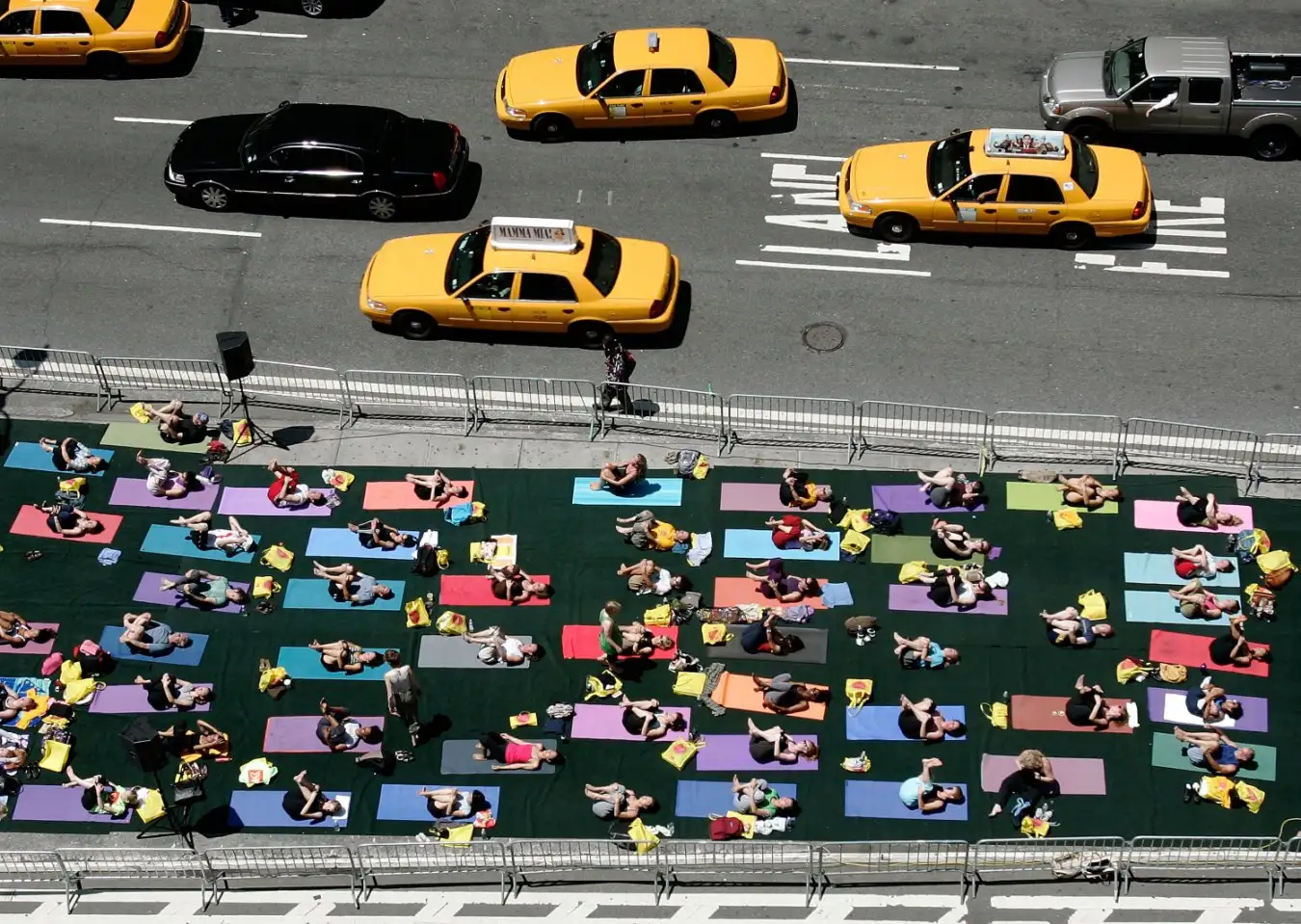 People doing yoga in NYC next to a busy road