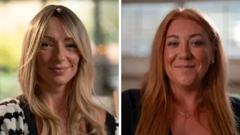BBC Two women are smiling at the camera, the one on the left, Ellen, has long blonde hair. The one on the right, Tanya, has long red hair