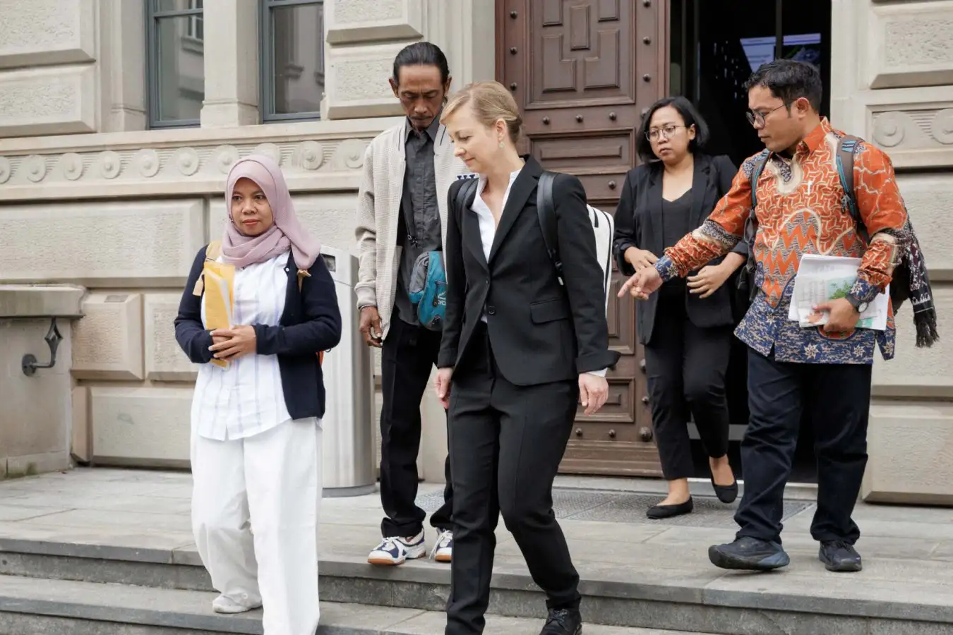 Plantiffs Ibu Asmania and Arif Pujianto after their court hearing in Zug, Switzerland