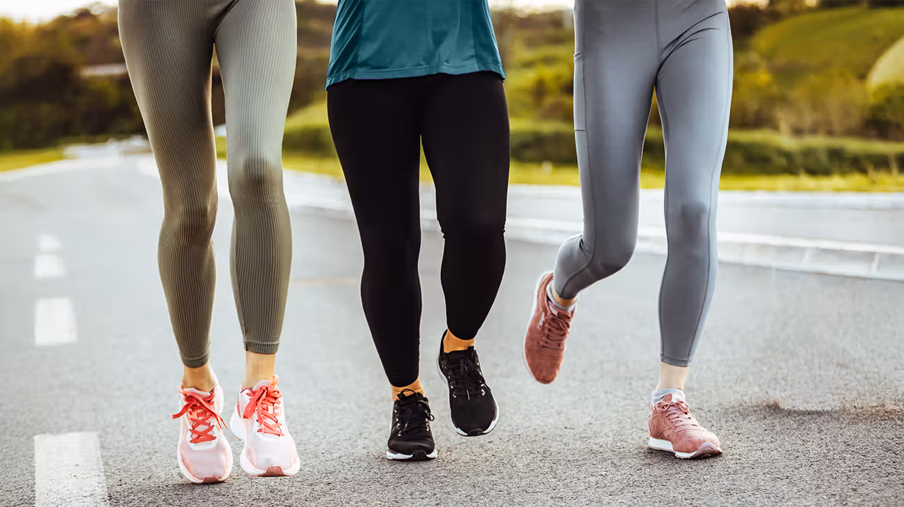 Legs of three females walking outside