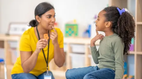 Getty  Images Speech and language therapist with child