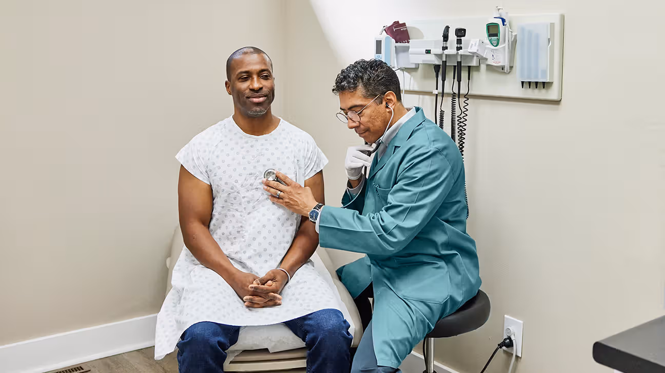 Male in his mid-30s getting a cardiovascular screening from a doctor