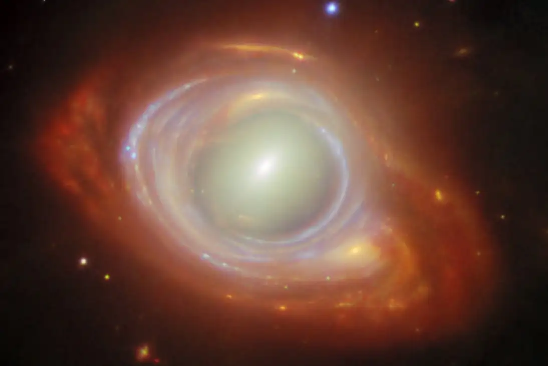 This new NASA/ESA/CSA James Webb Space Telescope Picture of the Month features a rare cosmic phenomenon called an Einstein ring. What at first appears to be a single, strangely shaped galaxy is actually two galaxies that are separated by a large distance. The closer foreground galaxy sits at the center of the image, while the more distant background galaxy appears to be wrapped around the closer galaxy, forming a ring.?? Einstein rings occur when light from a very distant object is bent (or ???lensed???) about a massive intermediate (or ???lensing???) object. This is possible because spacetime, the fabric of the Universe itself, is bent by mass, and therefore light travelling through space and time is bent as well. This effect is much too subtle to be observed on a local level, but it sometimes becomes clearly observable when dealing with curvatures of light on enormous, astronomical scales, such as when the light from one galaxy is bent around another galaxy or galaxy cluster. When the lensed object and the lensing object line up just so, the result is the distinctive Einstein ring shape, which appears as a full circle (as seen here) or a partial circle of light around the lensing object, depending on the precision of the alignment. Objects like these are the ideal laboratory in which to research galaxies too faint and distant to otherwise see. The lensing galaxy at the center of this Einstein ring is an elliptical galaxy, as can be seen from the galaxy???s bright core and smooth, featureless body. This galaxy belongs to a galaxy cluster named SMACSJ0028.2-7537. The lensed galaxy wrapped around the elliptical galaxy is a spiral galaxy. Even though its image has been warped as its light travelled around the galaxy in its path, individual star clusters and gas structures are clearly visible. The Webb data used in this image were taken as part of the Strong Lensing and Cluster Evolution (SLICE) survey (programme 5594), which is led by Guillaume Mahler at University of