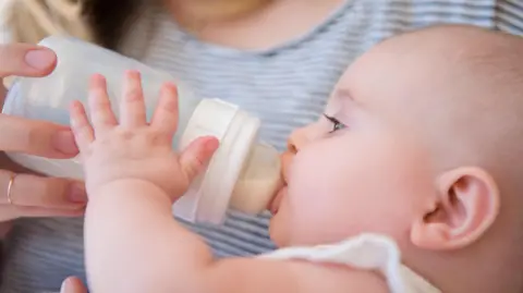Getty Images Baby drinking milk from a bottle 