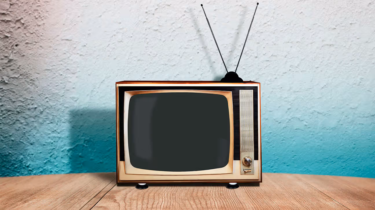 A retro tv against a blue and white wall