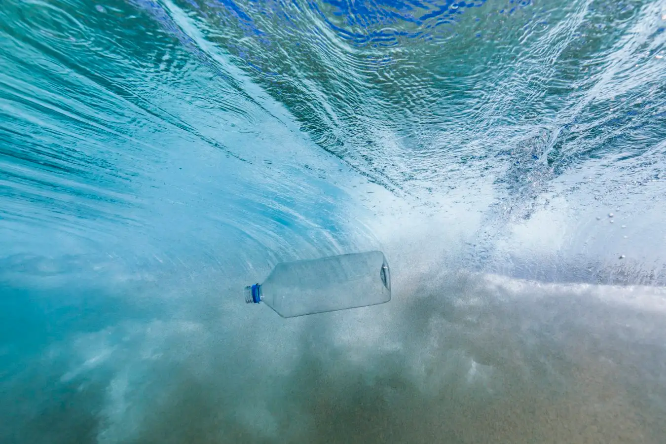 Plastic bottle in a breaking wave