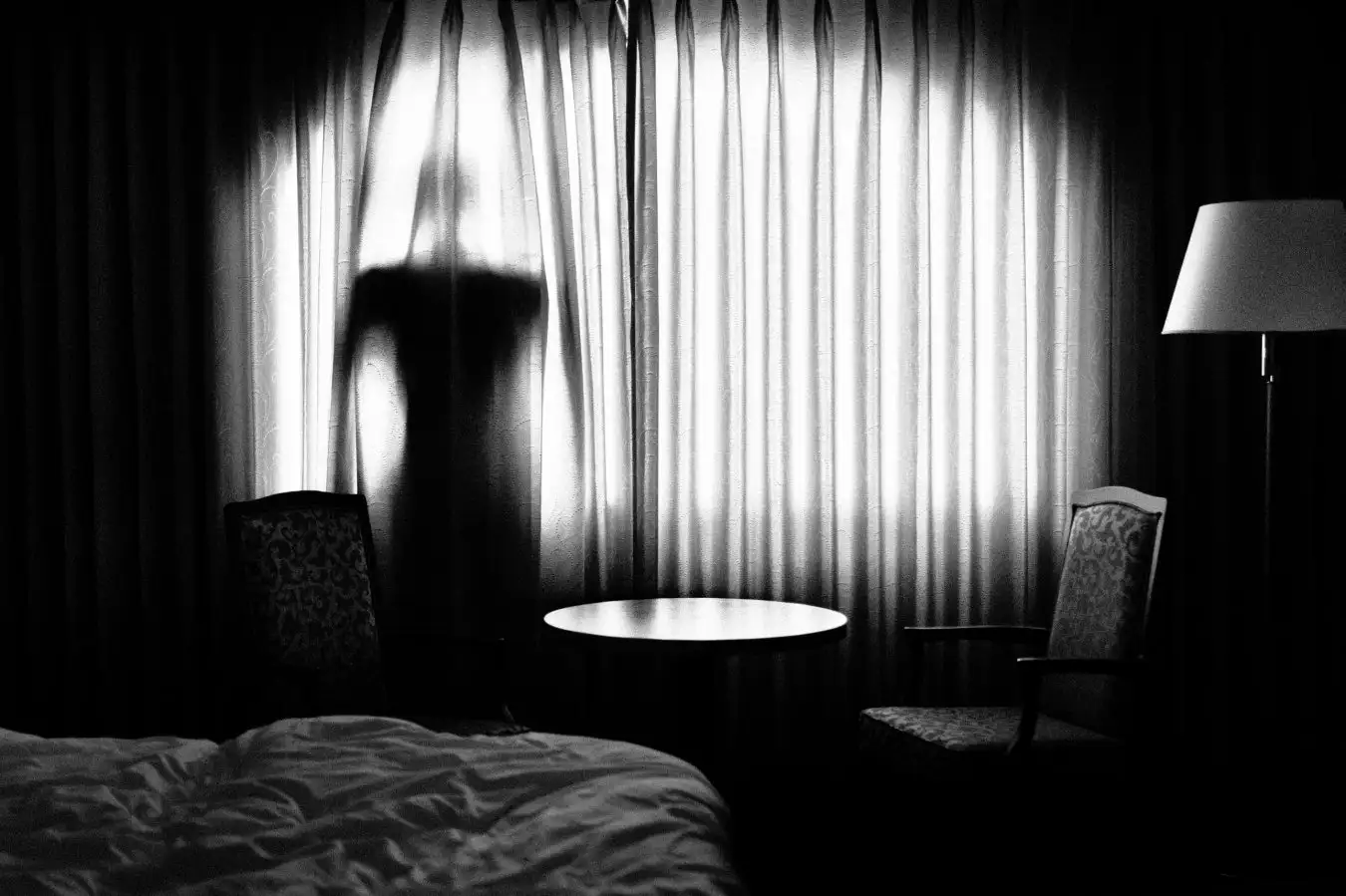 Man behind a curtain back