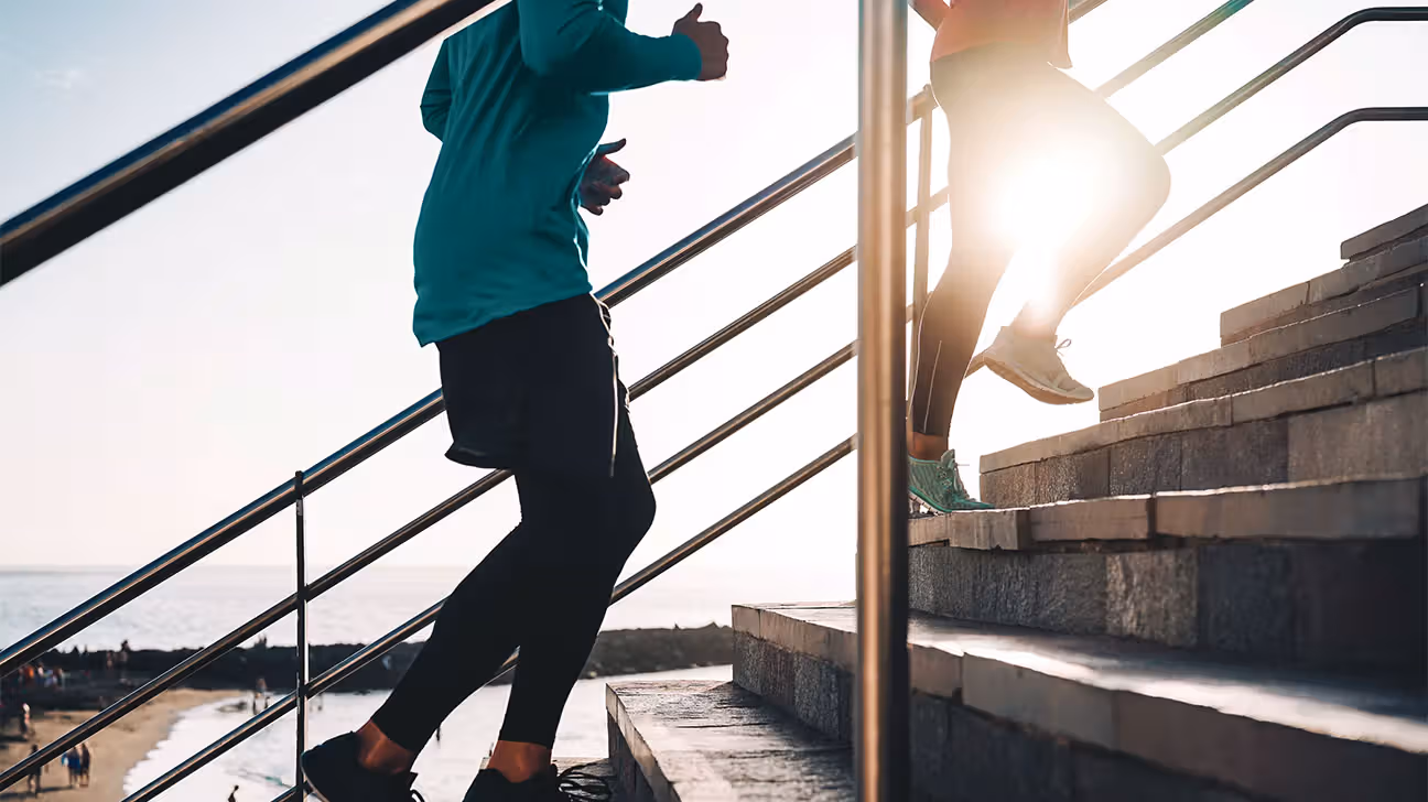 View of bottom half of a person's body while they are running up stairs outside