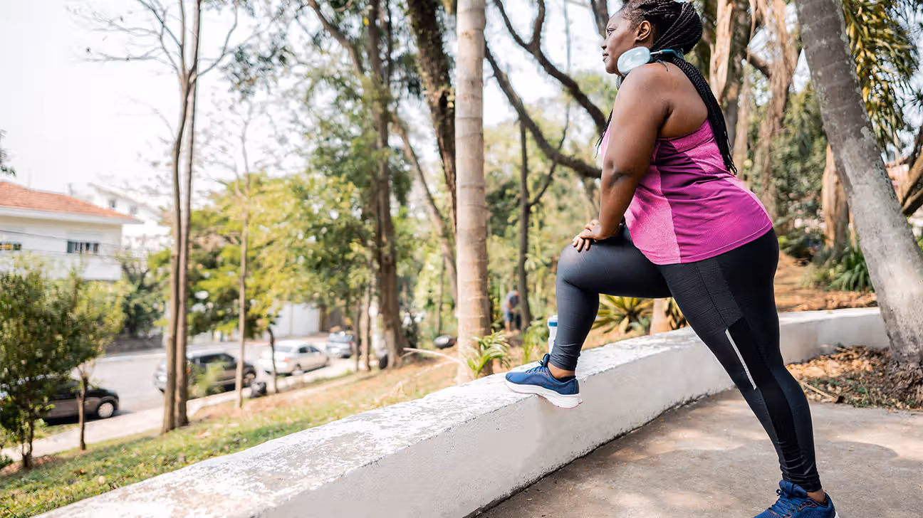 Female stretching hamstrings outdoors