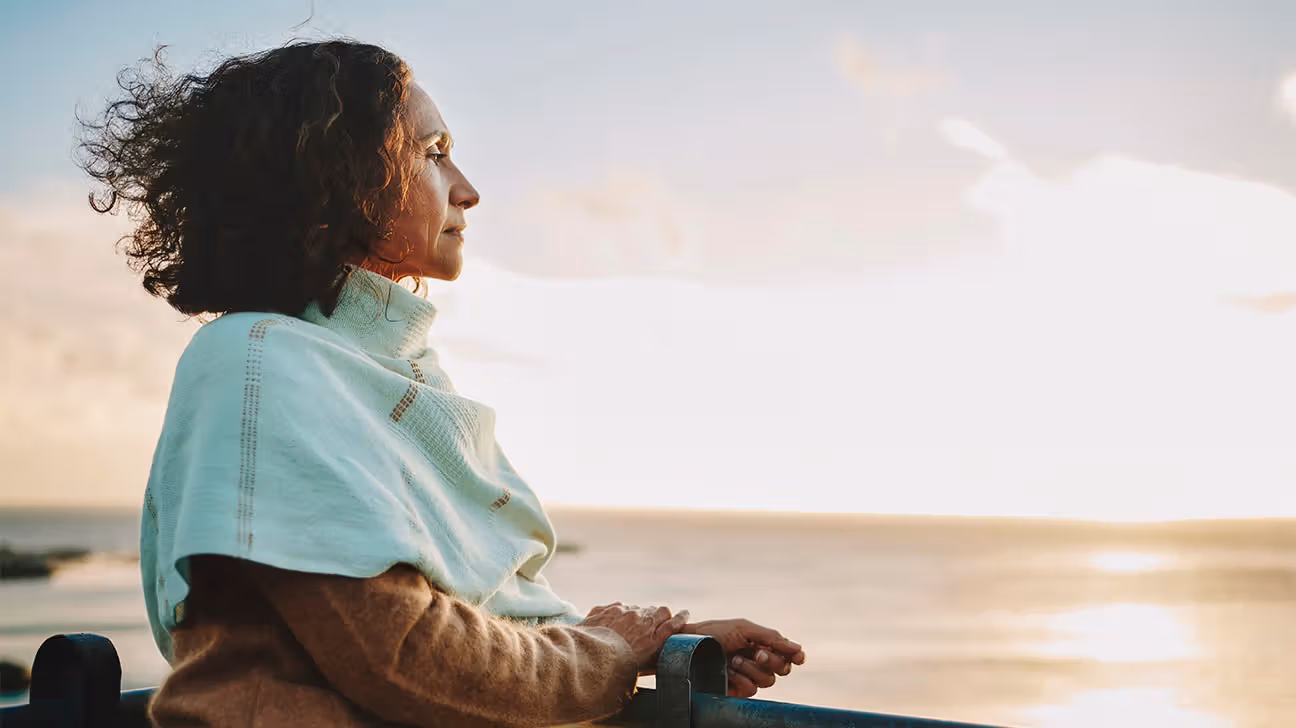 Older Female watching the sunset at the beach
