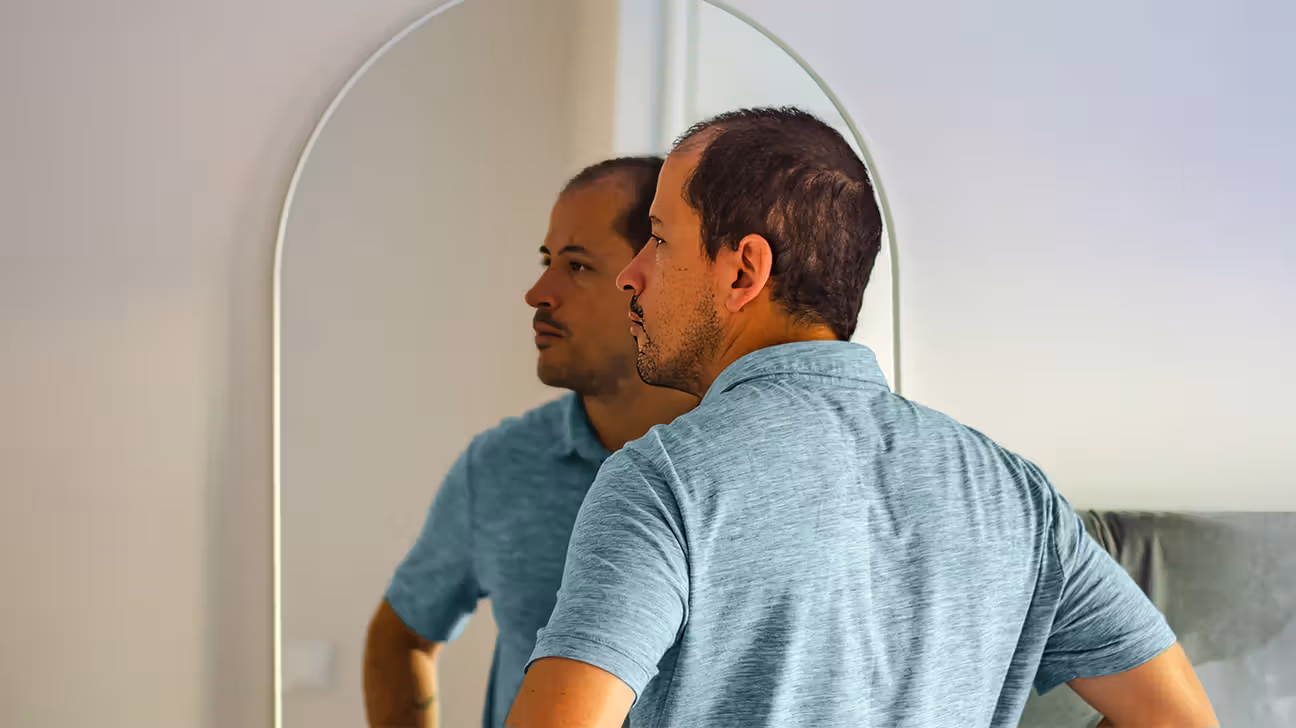 Middle-aged male looking in a mirror