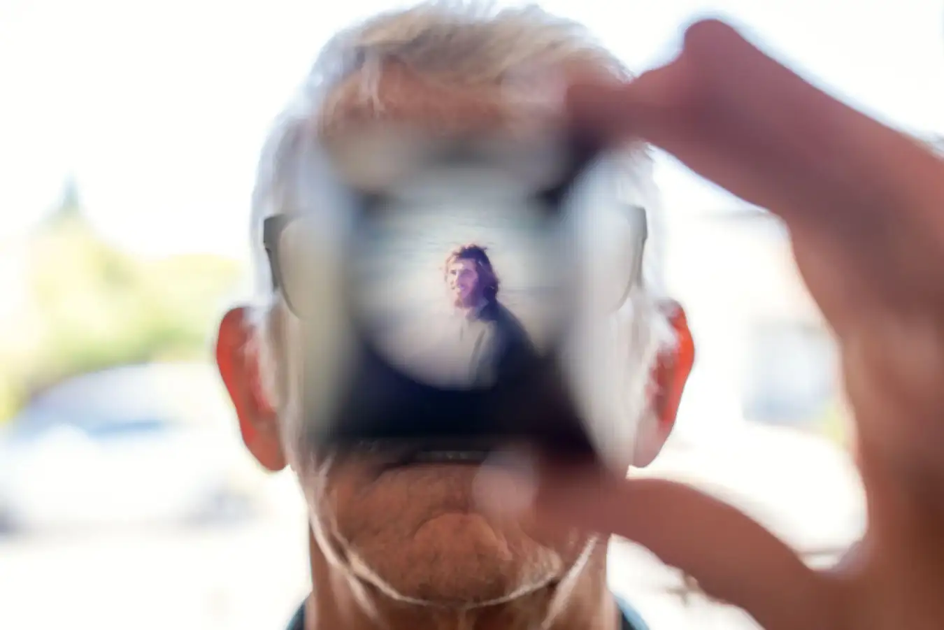 3D6CP11 Christy Morrill, 72, who lost decades of memories to autoimmune encephalitis, holds up a viewfinder with a slide film of himself as a college student while looking through old photographs at his home, Wednesday, Aug. 20, 2025, in San Carlos, Calif. (AP Photo/David Goldman)
