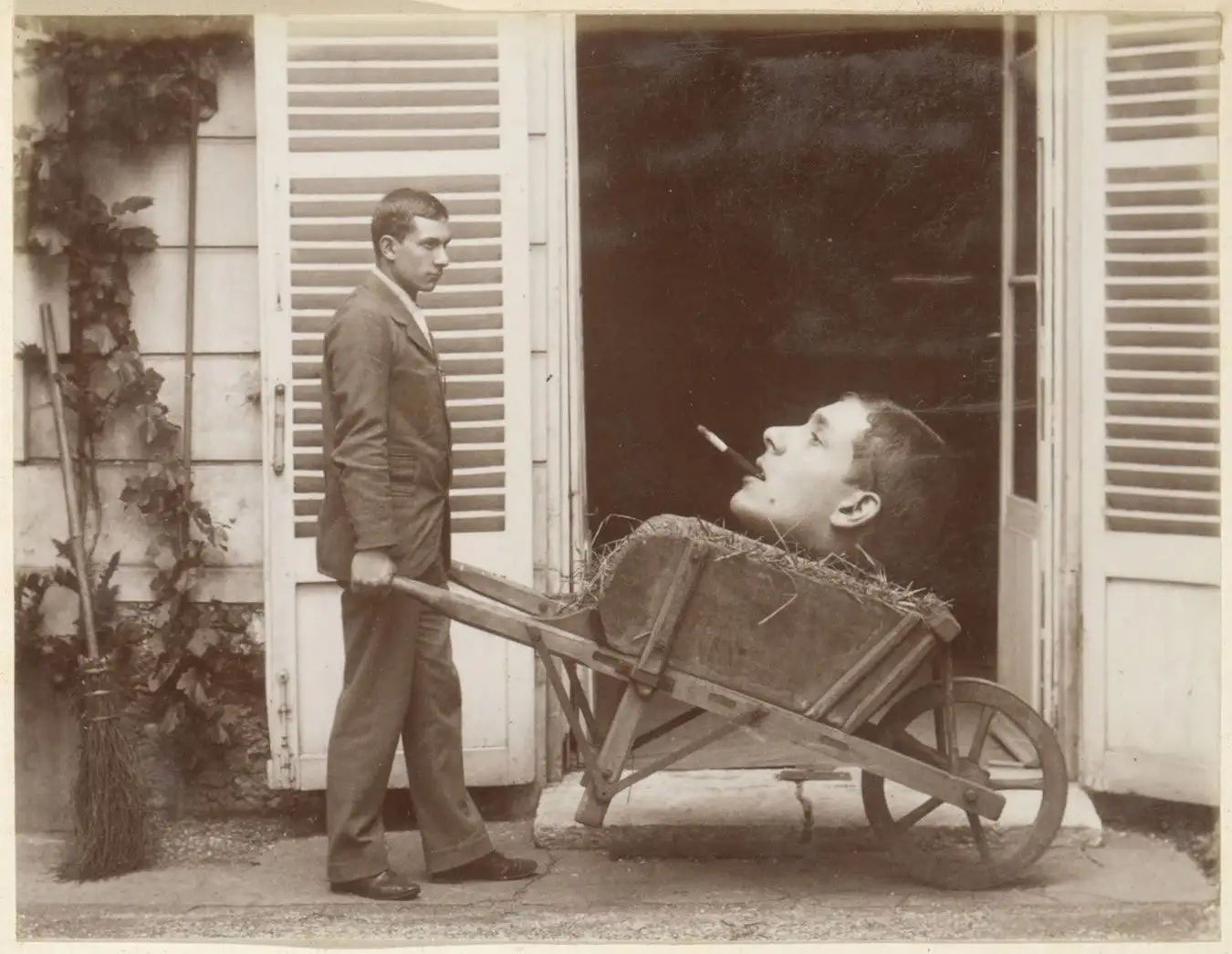 Photomontage of a man pushing a wheelbarrow containing a head, anonymous, c.1900???c.1910.