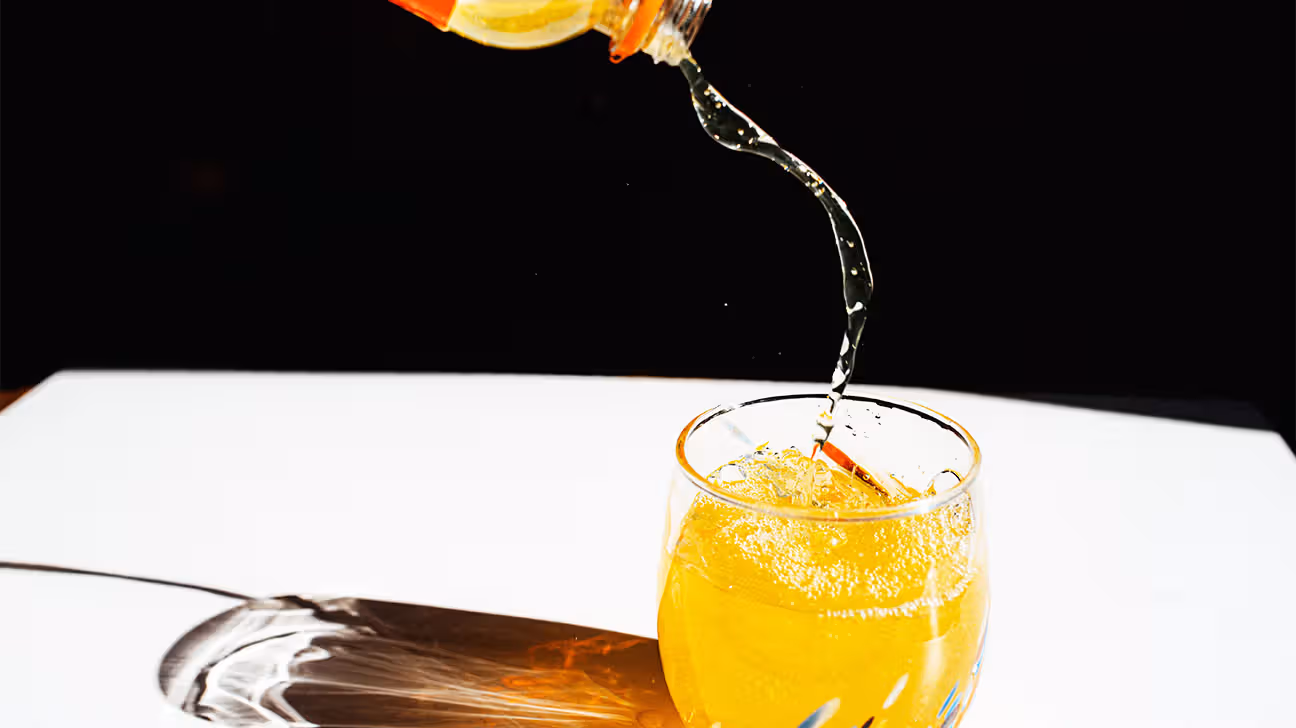Orange liquid being poured into a glass