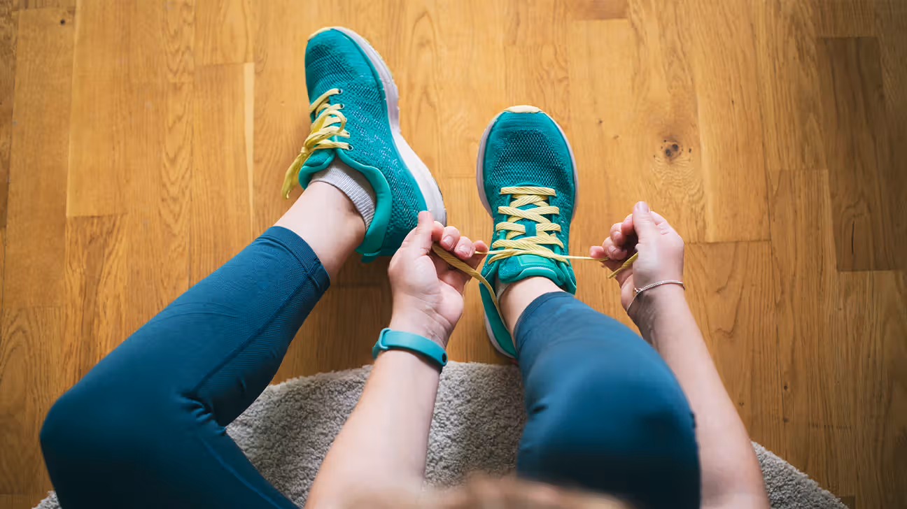 Female tying running shoes