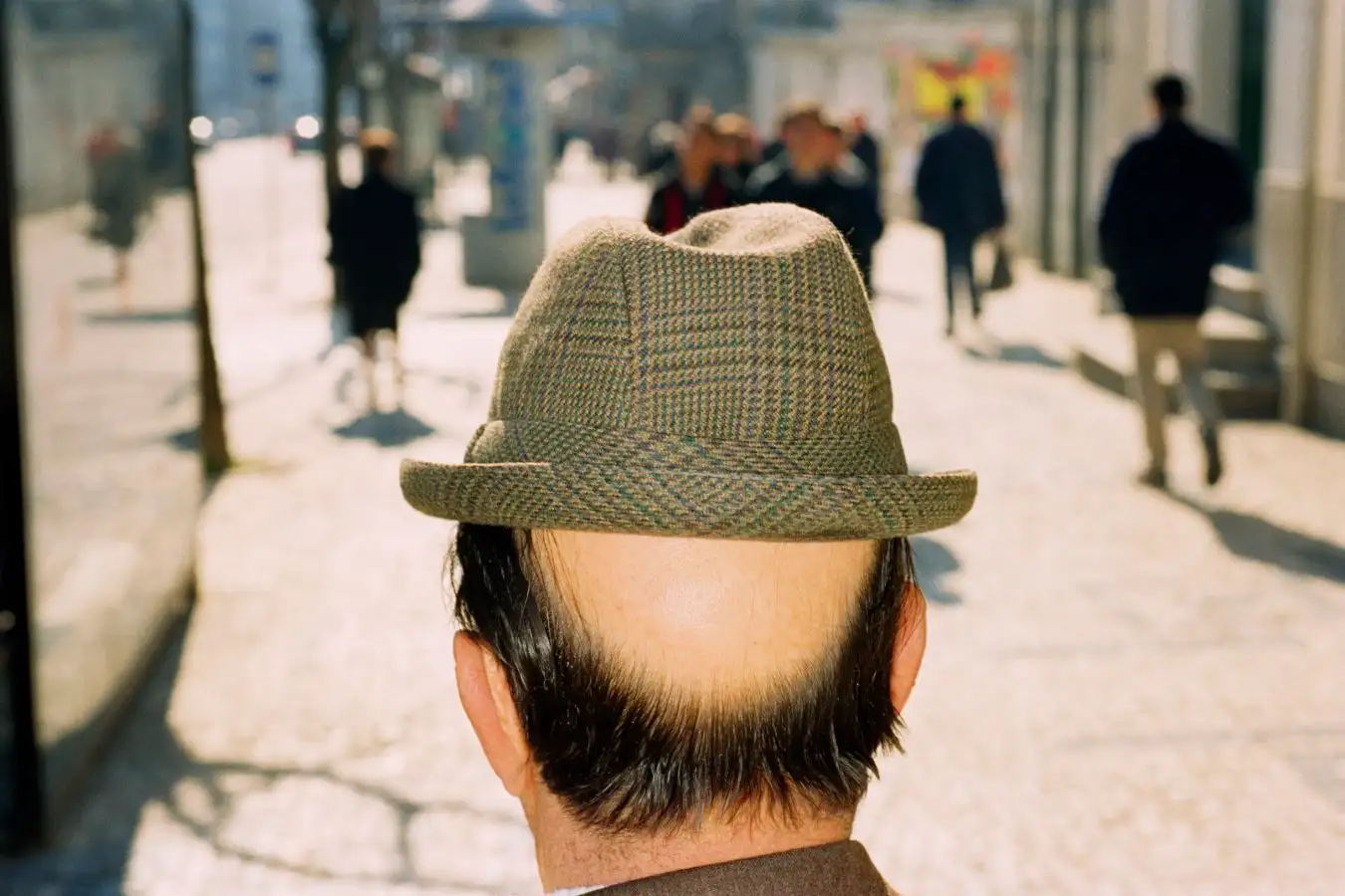 A balding man in a hat