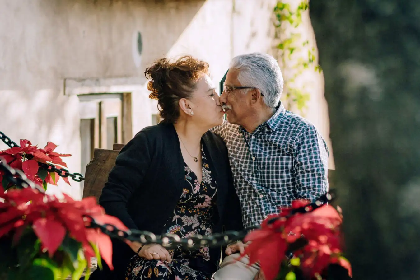 An older couple engaged in a kiss