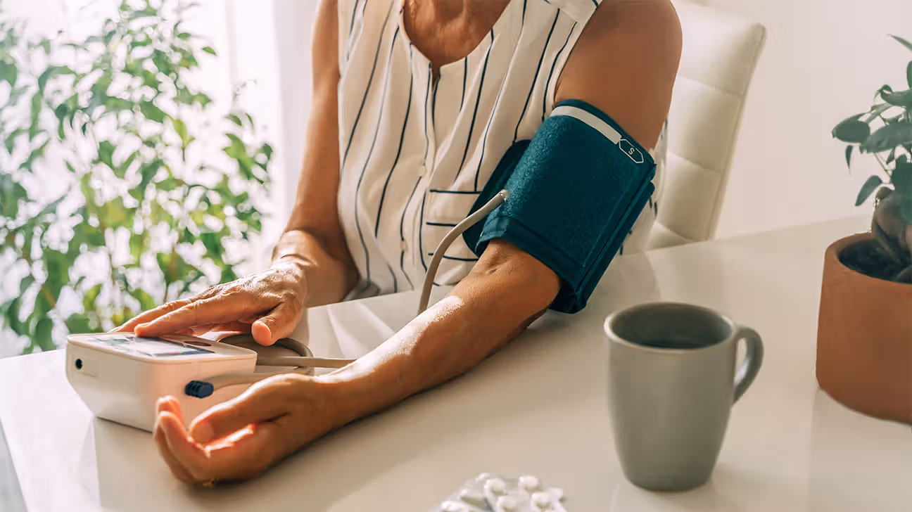 Female checking her blood pressure with a BP cuff