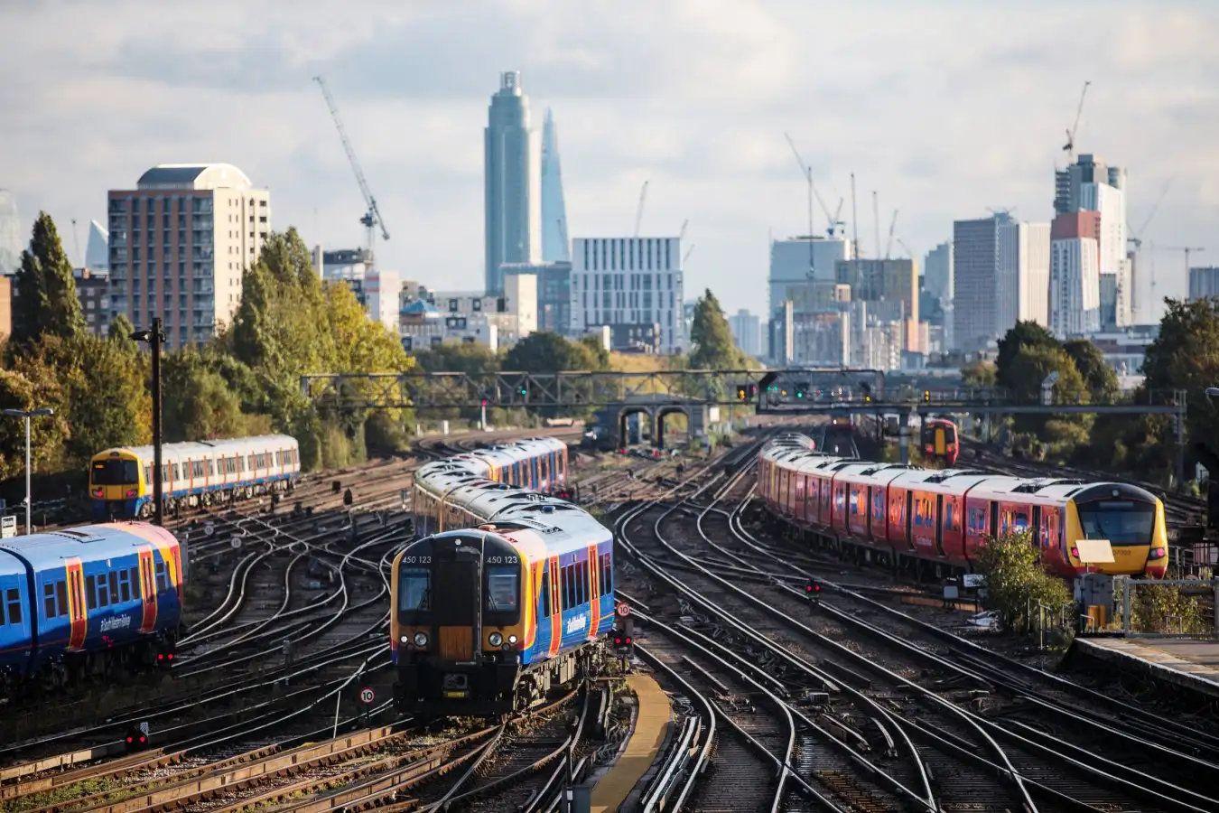 Trains arrive at and depart from Clapham Junction Station in London