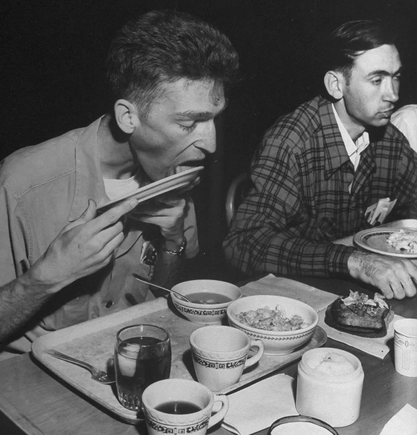 Participants in the Minnesota starvation experiment licking a plate clean