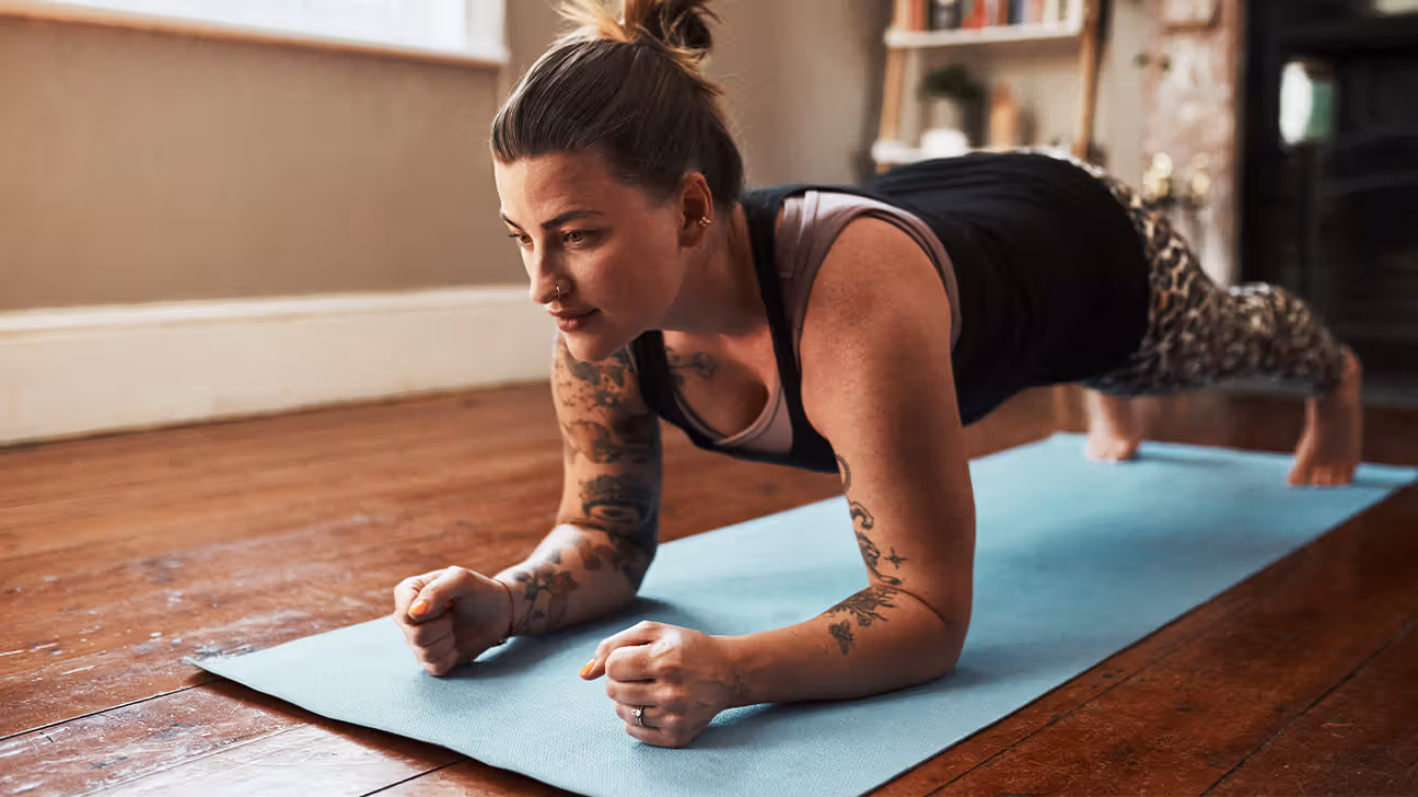 Female doing a plank in her living room