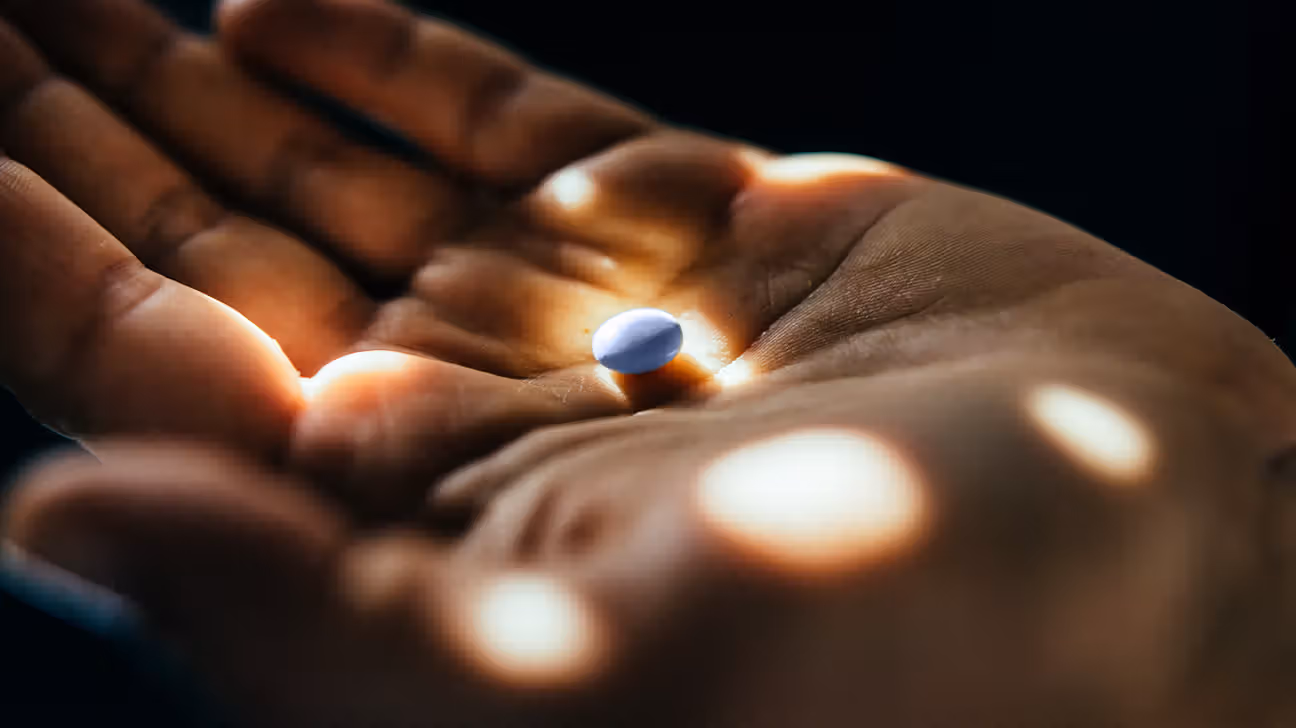 Closeup of blue pill in palmx
