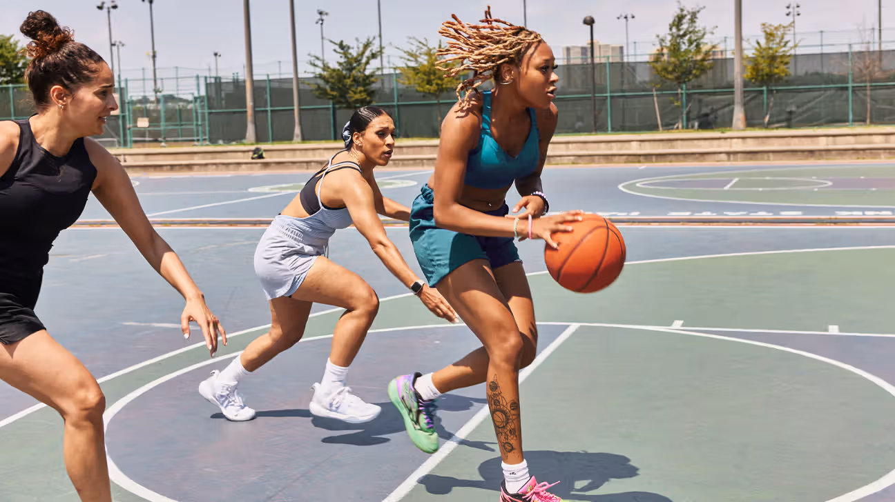 Three women playing basketball.