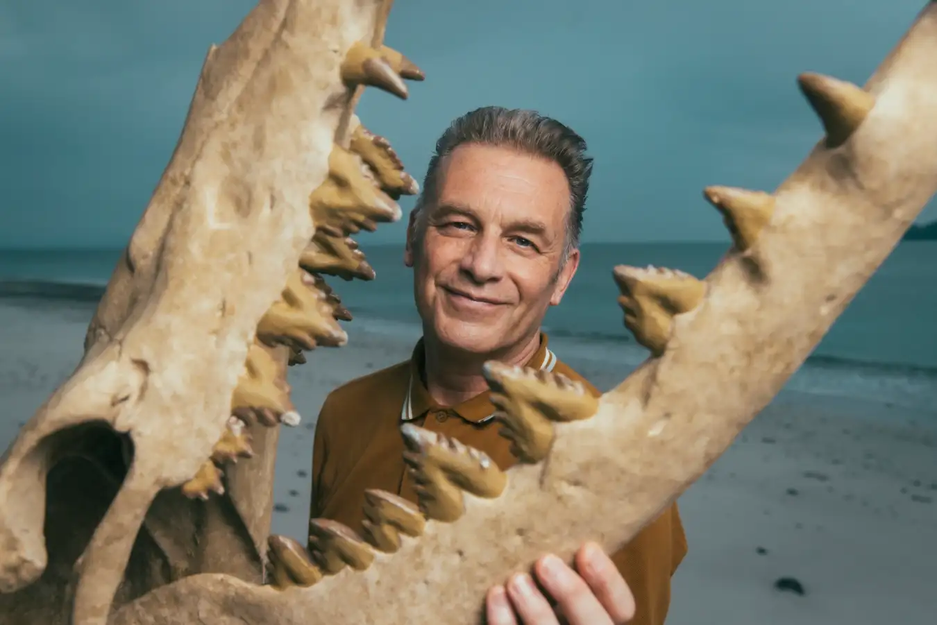 Chris Packham in his new series Evolution, holding a replica skull of Dorudon atrox, an ancient relative of dolphins