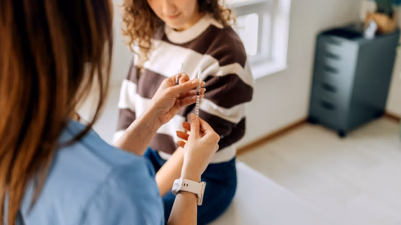 A healthcare professional giving an injection to a female