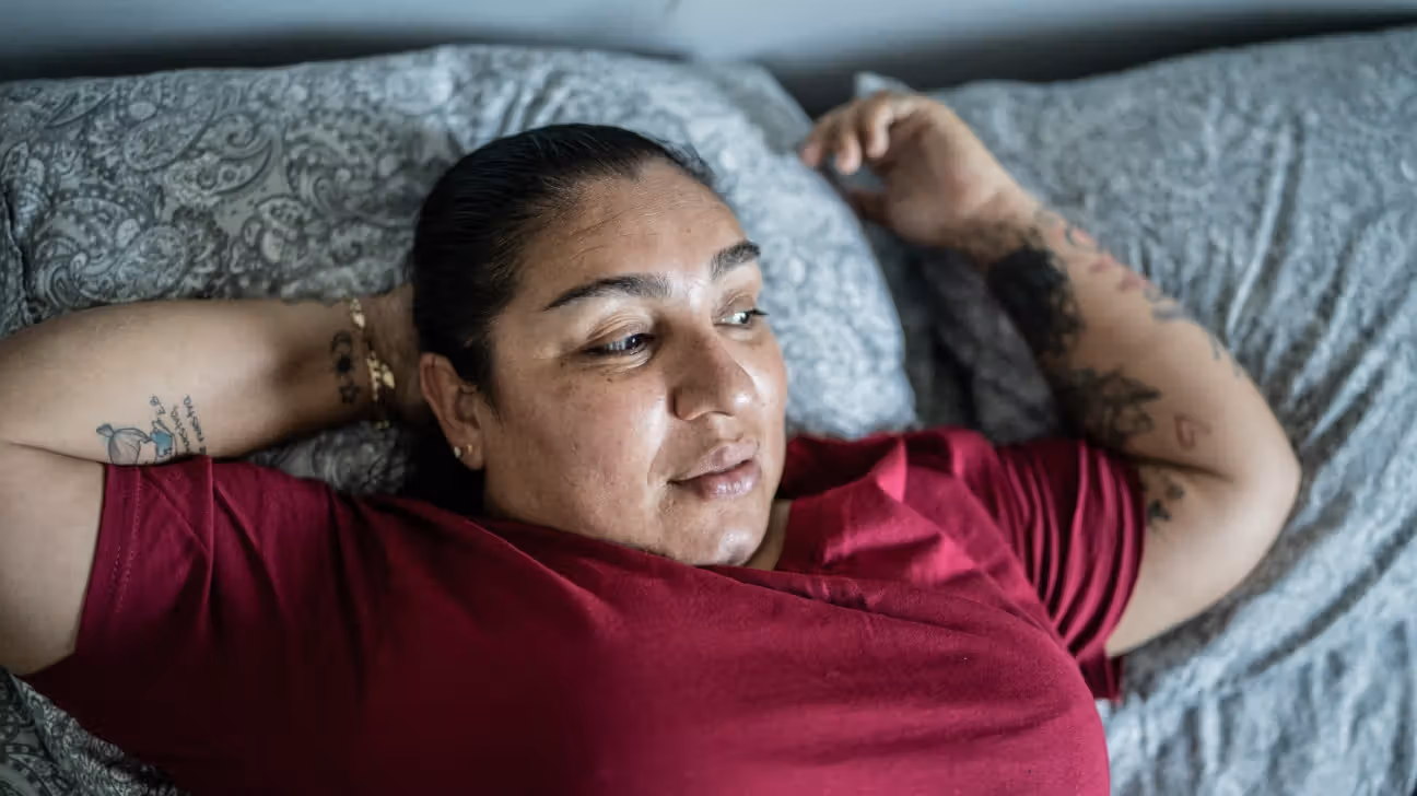 A woman lying on a bed.