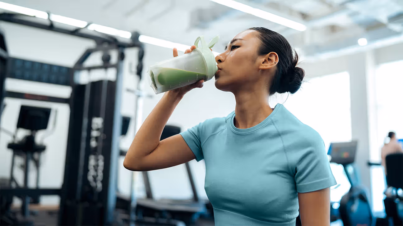 Female drinking creatine shake at gym