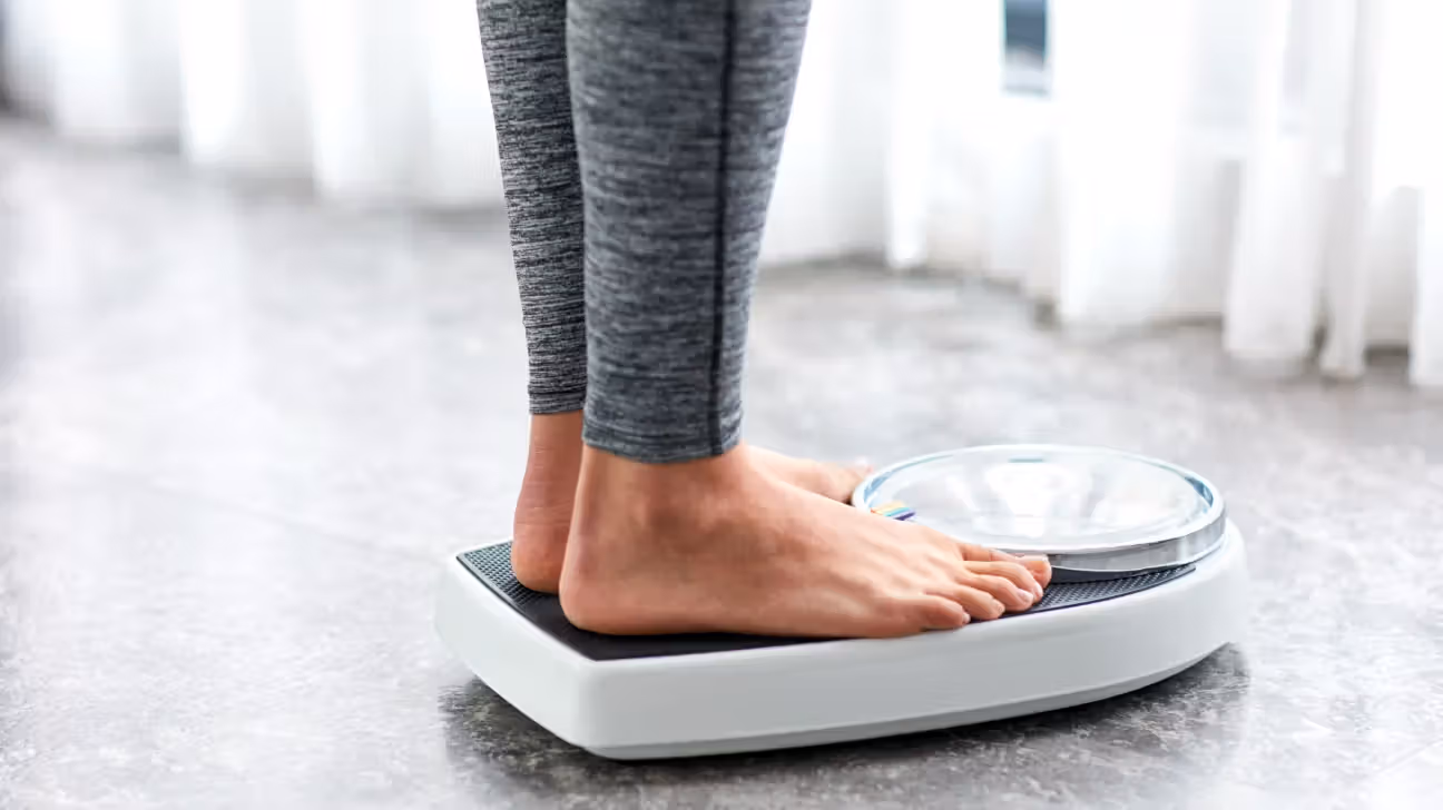 Image of a female's feet while she is standing on a scale